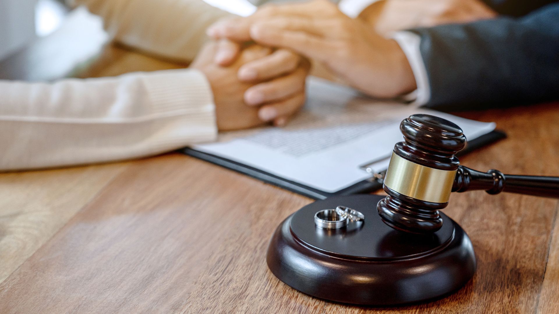 Faceless people with male hands over divorce document - the divorce process explained by Kelly Jordan Family Law. 