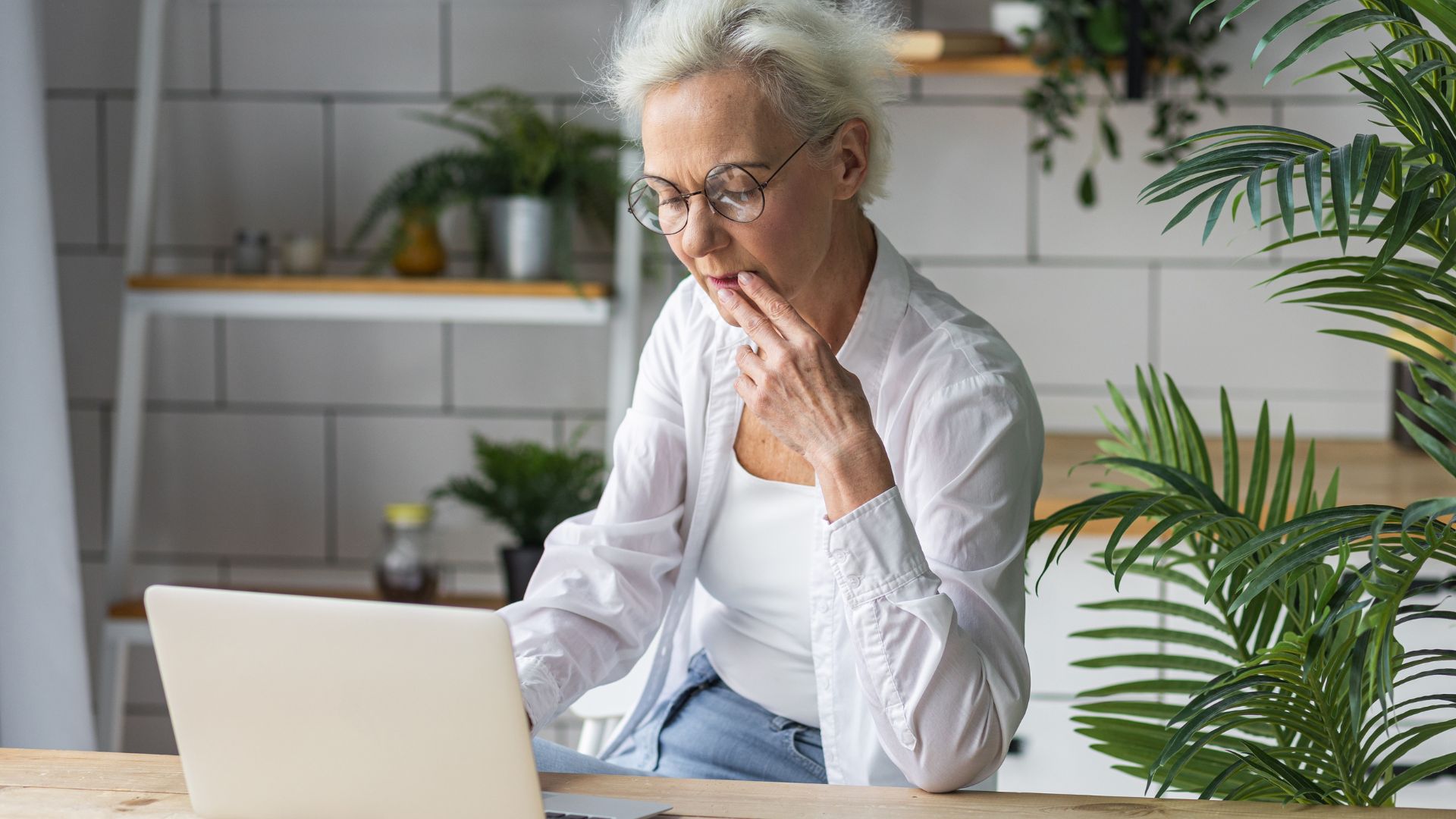 Woman looking at a laptop, getting information about divorce in Ontario. 