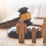 Three wood figures representing a family and a gavel - family law in Toronto, Ontario.