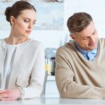 A couple sitting at a table - difference between separation and divorce - Kelly Jordan Family Law.