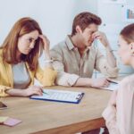 Couple meeting with a lawyer - insights from Kelly Jordan Family Law, on who is responsible for debt after separation.