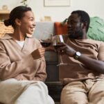 Couple sitting on a sofa - how to define cohabitation - Kelly Jordan Family Law.