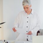 Woman looking at documents - spouse entitlement to pension after divorce - Kelly Jordan Family Law.