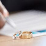 Faceless person writing with rings in front - spousal support lawyers at Kelly Jordan Family Law.