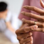 Faceless woman’s hands removing ring - difference between annulment and divorce - Kelly Jordan Family Law.