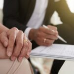Faceless couple looking over document - divorce mediation services in Toronto with Kelly Jordan Family Law.